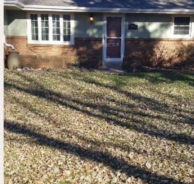 Before: front lawn buried in fallen leaves