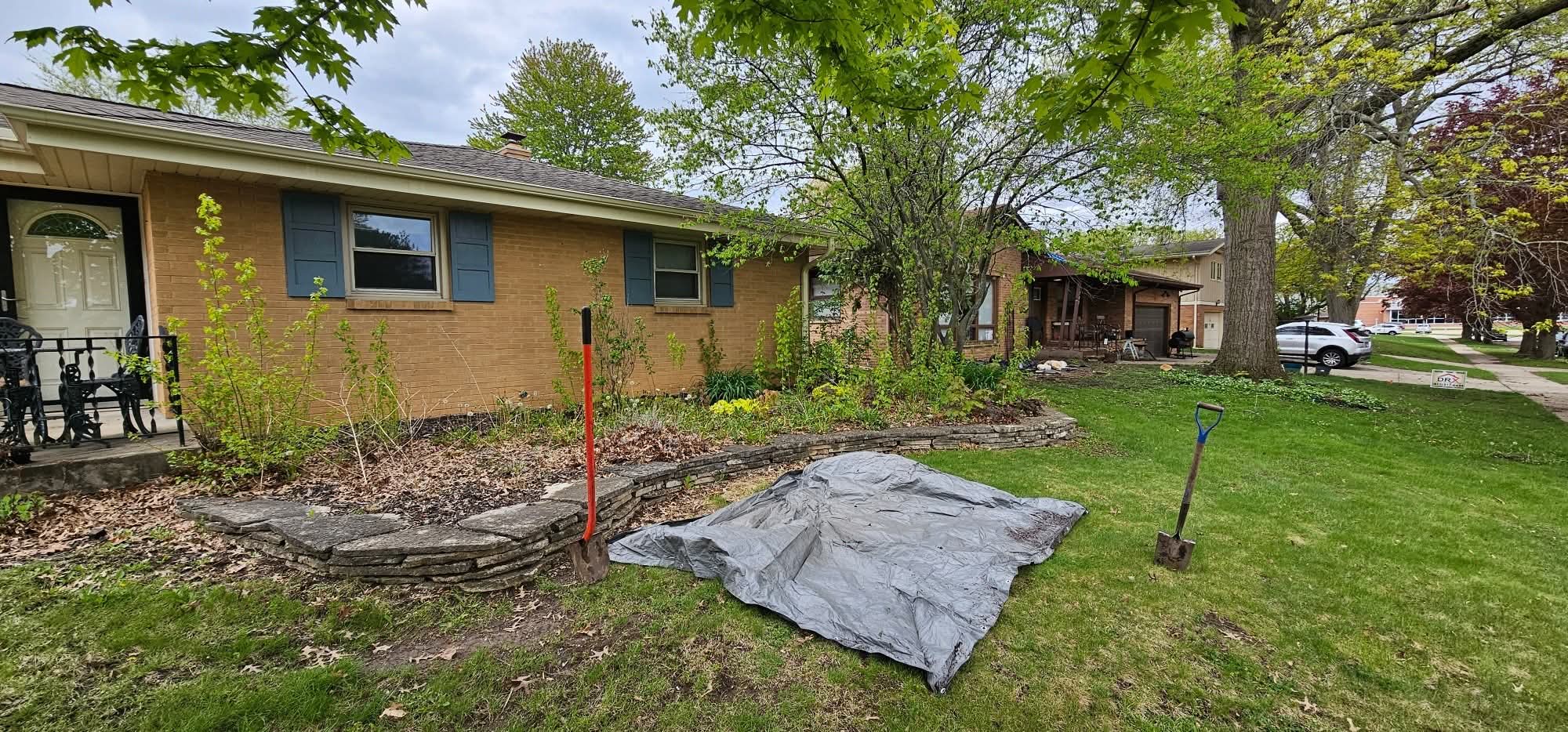 Before: overgrown front bed along the porch