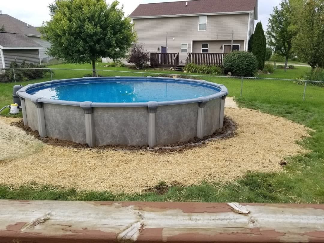 Before: straw-covered new seed around a pool