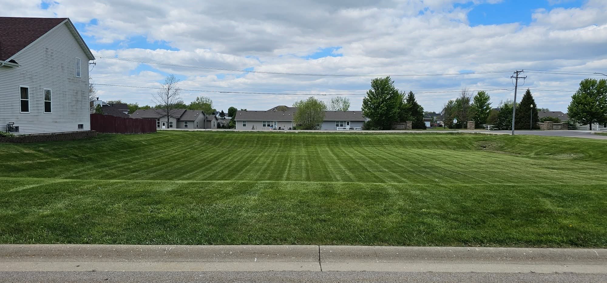 Large commercial lot mowed with stripes