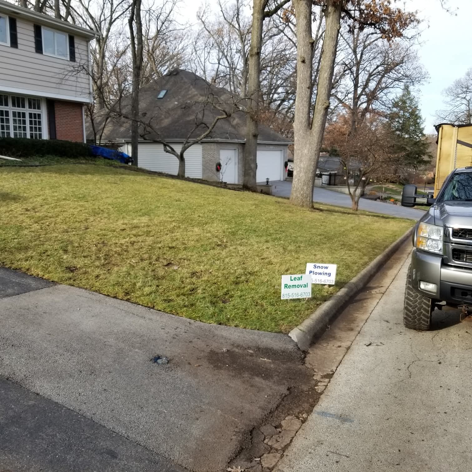 Christian's Leaf Removal and Snow Plowing yard signs next to their truck